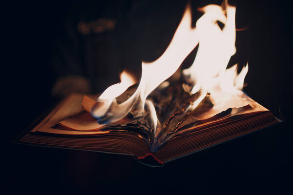 Book burns on dark background