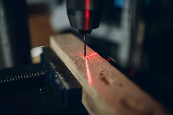 Drilling machine with laser sight in the workshop