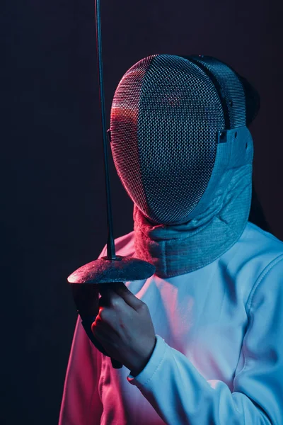 Fencer woman with fencing epee saber sword. Color light.