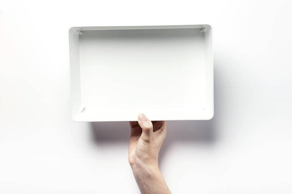 holding a white box
