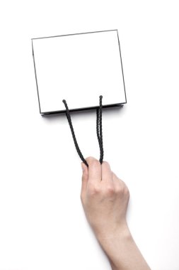 Kağıt alışveriş çantası elinde.