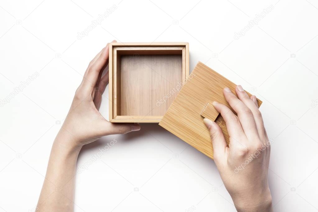 holding a bamboo box