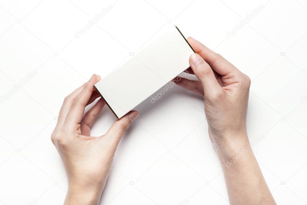 holding a white package.