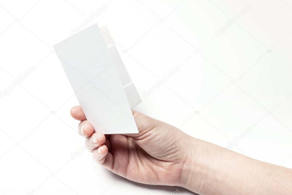 holding a white postcard.