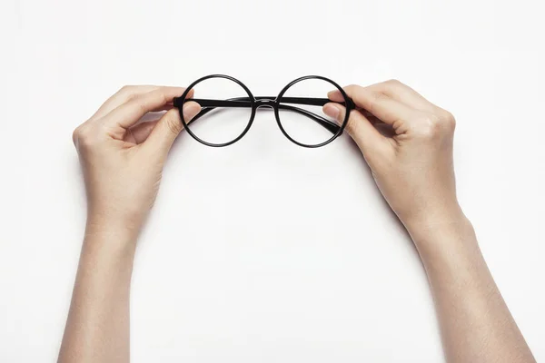 Mão mulher segurando óculos de olho isolado no fundo branco — Fotografia de Stock