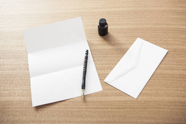 vintage and retro concepts (fountain pen and letter) on daylight wood desk