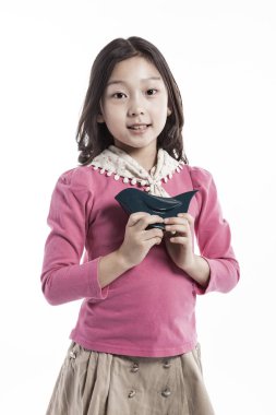 seramik bir kuş tutan bir kız. (pembe bluz giyiyor) 