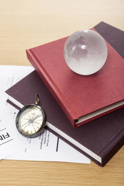 workspace (compass, crystal globe, hardcover book, document)