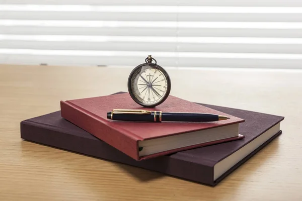 antique interior concept. (compass, book and pen)