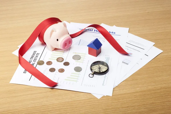 financial concept. housing funds. (piggy bank, document, coins, key, wood block, ribbon)