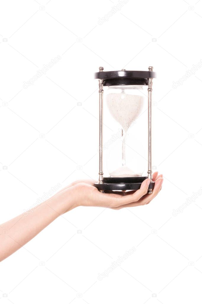 Woman hand hold a sand timer isolated on white.