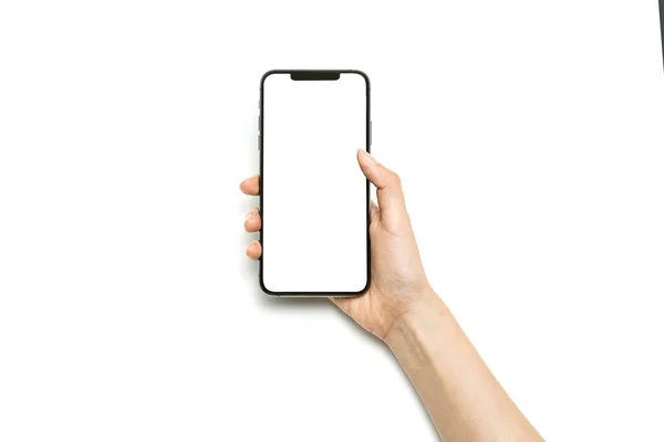 女性の手は白い上に隔離されたスマートフォンを保持 — ストック写真