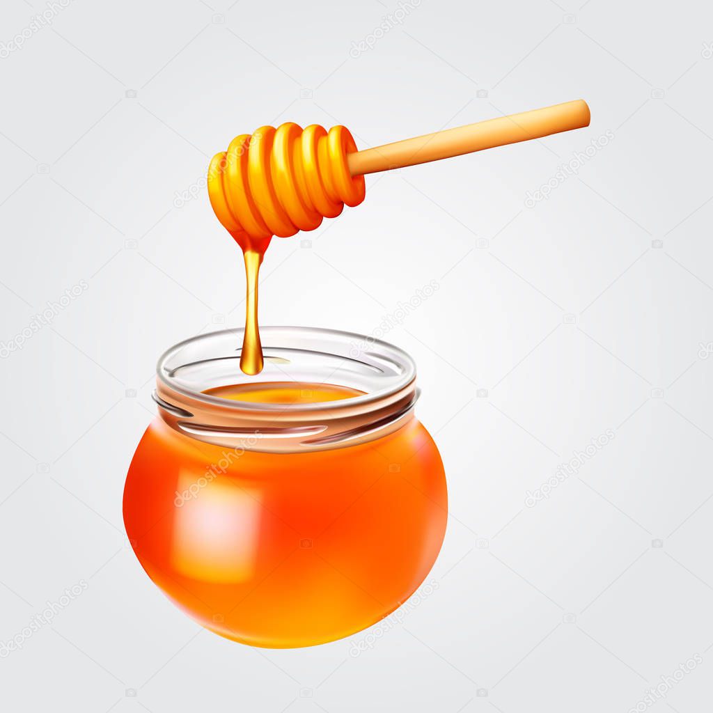 Honey droplets flowing from wooden dipper in honey jar.