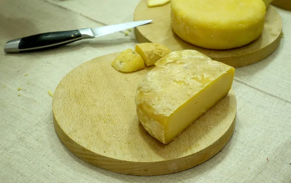 カウンターの上のチーズの種類の全体および切欠き材のヘッドのビュー — ストック写真