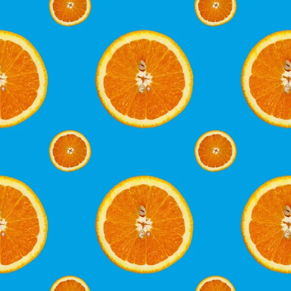 Creative pattern made of orange on blue background. Food concept. — Stock Photo, Image