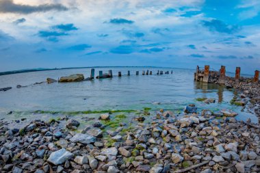 Beautiful landscape with dramatic stormy  clouds and stones over the Razim Razelm lake, Sarichioi, Tulcea, Romania