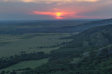 Günbatımı gökyüzü ve yeşil bir orman, hava manzarası, Dobrogea Romanya