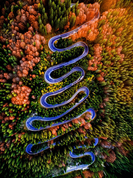 Beautiful aerial view of a curvy winding road with serpentine and colorful autumn trees, Cheia, DN1A, Romania
