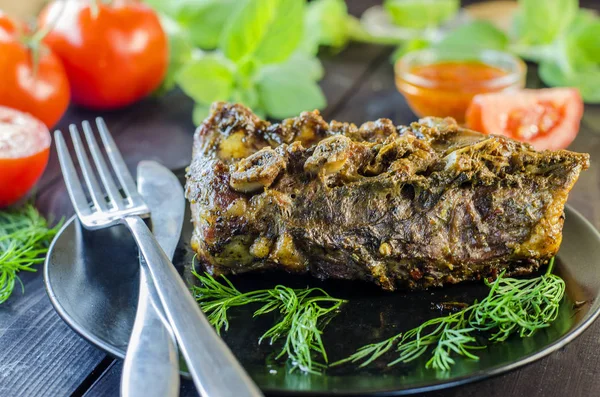 Pork meat on ribs baked in an oven — Stock Photo, Image