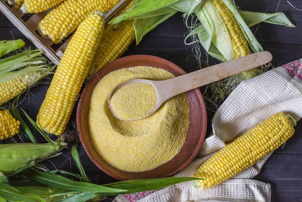 small corn grits in a bowl and rocked corn on the table