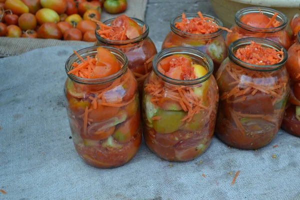 Homemade food. Natural products from the garden. Village, cottage, farm. Preservation. Blanks for the winter. Marinated. Grated carrot, Red and yellow tomatoes in jars