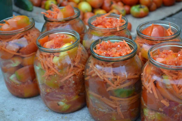 Preservation. Homemade food. Natural products from the garden. Village, cottage, farm,. Tasty and healthy. Blanks. Marinated tomatoes. Grated carrot, Red and yellow tomatoes in jars