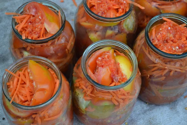 Preservation. Homemade food. Natural products. Grated carrot, Red and yellow tomatoes in jars