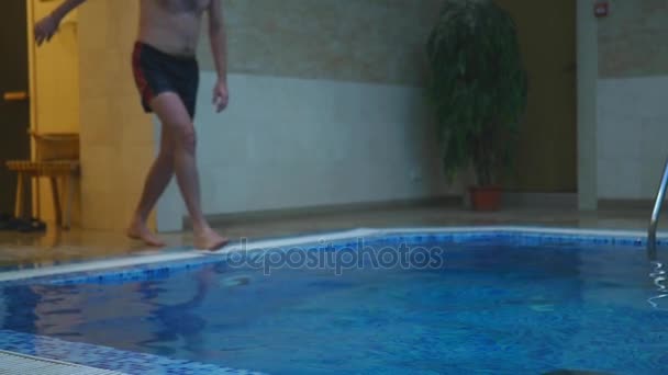 Um homem a saltar para a piscina — Vídeo de Stock