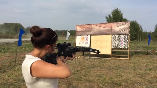 Strong young beautiful woman standing in a field in the dash and aim a crossbow at a target,. 1920x1080 — Stock Video