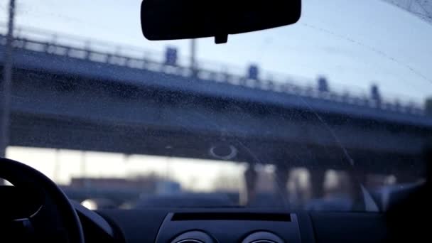 A car is driving over a road jammed with cars, it drives under a bridge, the sun blinds the eyes. Slow motion. 1920x1080. — Stock Video