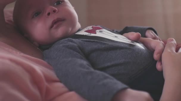 Little kid lies on his mothers breast in care and affection. SLOW MOTION. HD, 1920x1080. — Stock Video