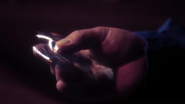 Twist golden shiny spinner in hands, with beautiful lights. HD, 1920x1080. Slow motion — Stock Video