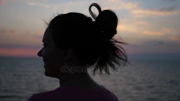 Ragazza soddisfatta ammira il tramonto al mare, sorridendo. HD, 1920x1080. rallentatore . — Video Stock