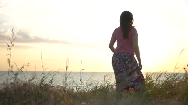 Glad tjej dansar på stranden i solnedgången bakgrunden. HD, 1920 x 1080. slowmotion. — Stockvideo