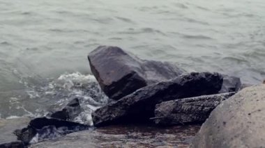Su sıçramalarına karşı büyük taşlar dalgalar sonu. HD, 1920 x 1080, ağır çekim.