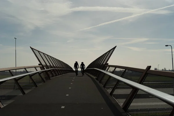 Bicycle bridge with cyclists — Stock Photo, Image