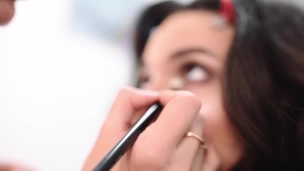Visage maestro hace maquillaje de ojos, maquillaje artista hace delineador de ojos, mujer ven al salón de belleza — Vídeos de Stock