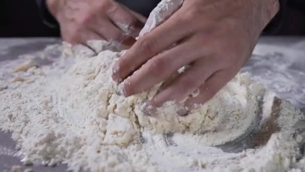 The cook kneads the dough, flour and water, bread and bakery, baking at the kitchen, cooking the food, food videos, chef at work — Stock Video