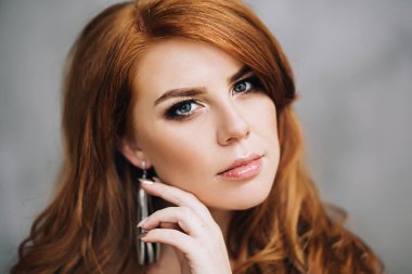 Attractive beautiful woman with red long hair watches to the camera, portrait of white aucasian woman, female portrait clipart