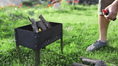 Adam yakacak odun şenlik, arka bahçe Barbekü açık ateş, Yaz Barbekü yemek pişirmek için sıcak kömürleri yapma atar