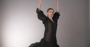 Uzun siyah elbiseli çekici bayan dansçı bale egzersizleri ve numaralar yapar, bale provası yapar, balerin sahne kostümlü dans adımları atar, dans stüdyosu dersi, 4k DCI 60p Prores karargahı