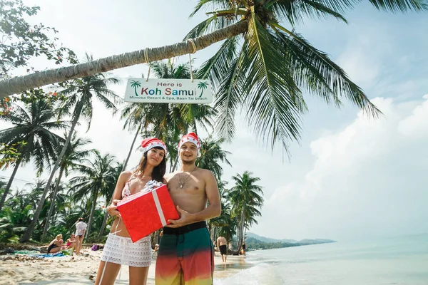Ζευγάρι στέκεται με το κιβώτιο δώρων στην παραλία — Φωτογραφία Αρχείου