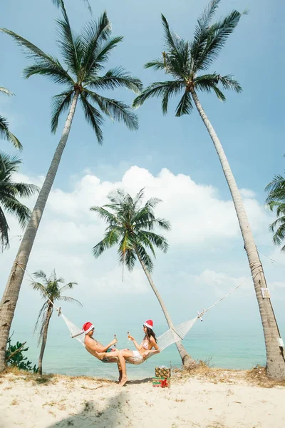 Pareja sentada en hamaca en la playa —  Fotos de Stock