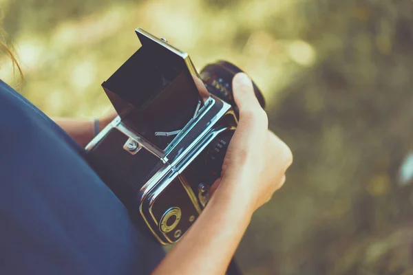 Woman hands holding vintage photo camera