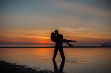 Gün batımında çiftin siluetleri