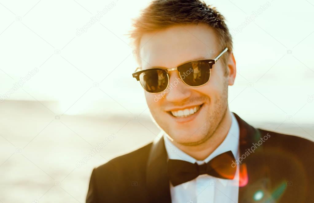 Young man in suit and sunglasses