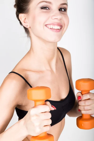 Активная спортсменка с гантелями, накачивающая мускулы бицепсами. фитнес концепция — стоковое фото