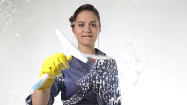 Joven ama de casa lavó la ventana con un spray, tela y detergente. Vidrio grande en espuma. Concepto de trabajo doméstico . — Vídeos de Stock