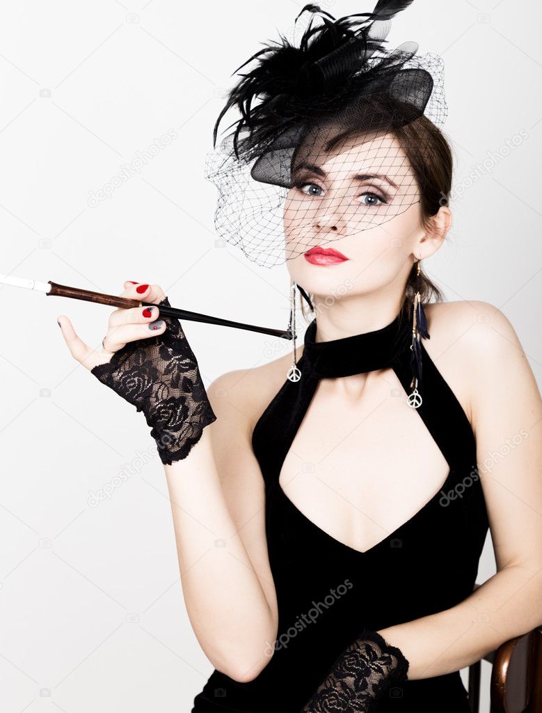Beauty retro female model with professional makeup and mouthpiece in hand