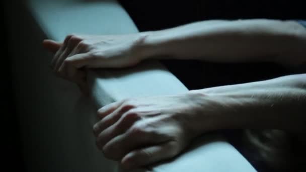 Close-up hands of a young woman lying on a bad. Girl crumples upholstery couch — Stock Video